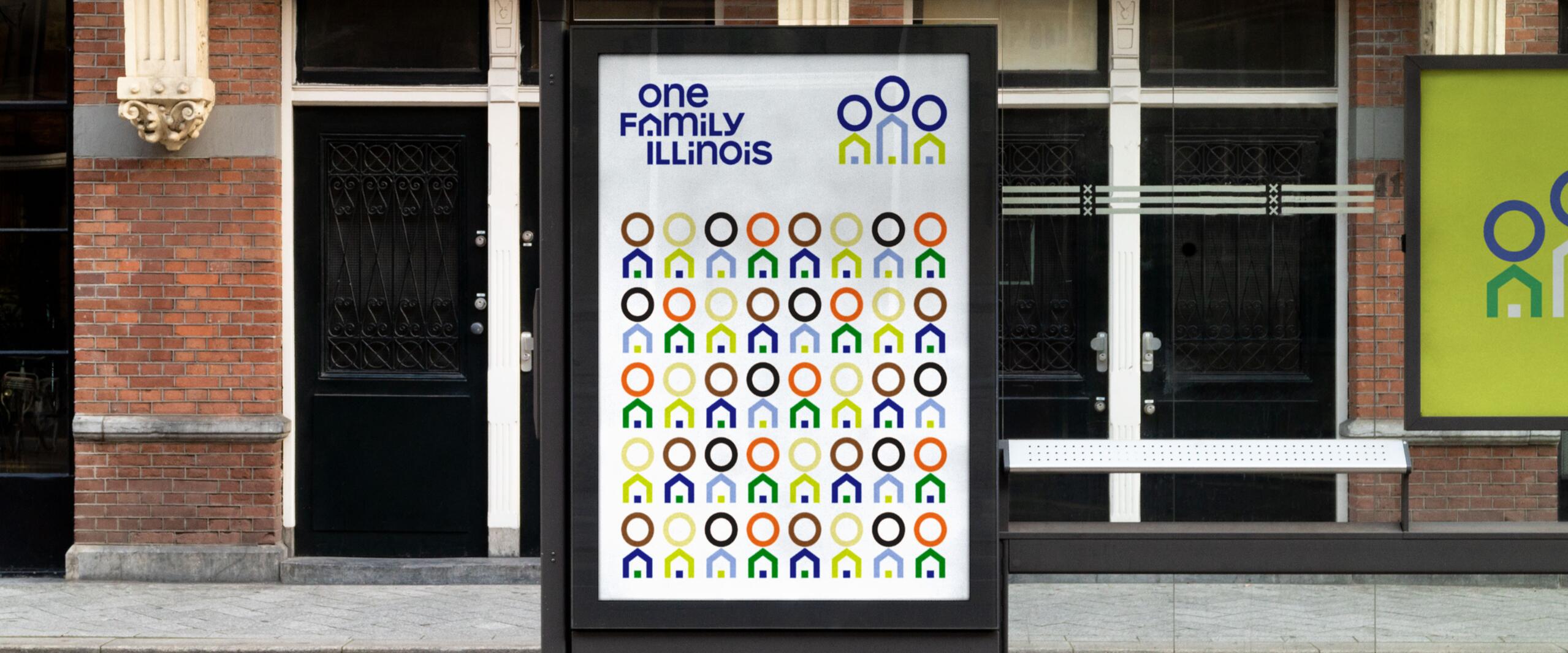 Bus stop advertisement with colorful circle and house icons on a white background, set against a brick building. Text and logos emphasize community in Illinois.