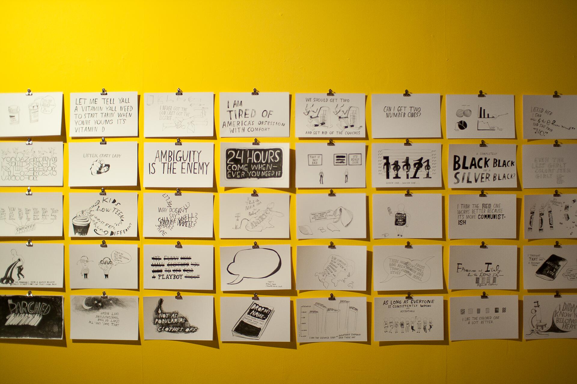 A series of hand-drawn illustrations and text displayed on a bright yellow wall, arranged in a grid pattern. Each paper is clipped individually, featuring various sketches, quotes, and graphical elements.