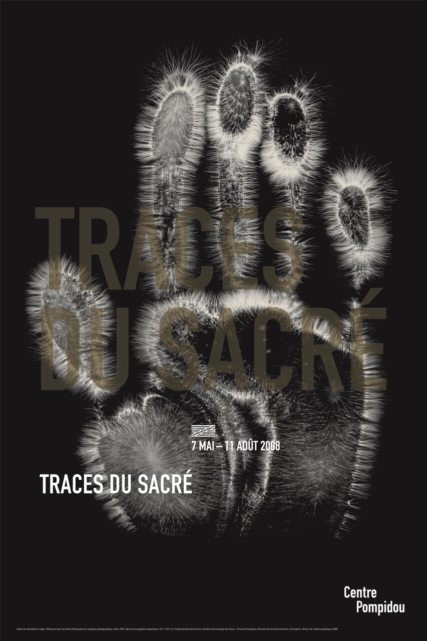 A black and white graphic of a handprint with radiating light patterns, overlaid with the text "TRACES DU SACRÉ." Poster for an event at Centre Pompidou.