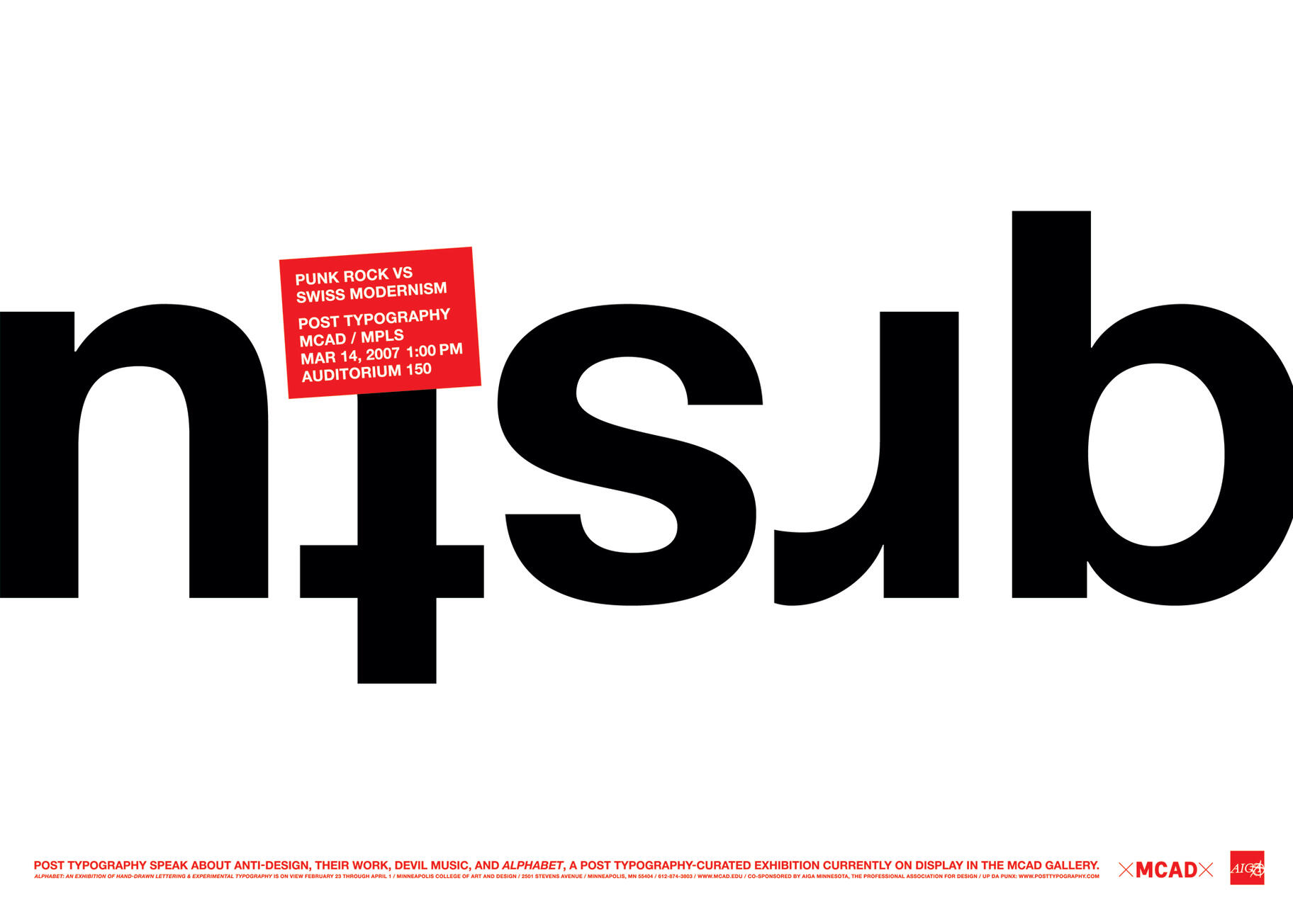 Bold black text reads "nism" upside down on a white background, with a small red informative card overlapping the text.