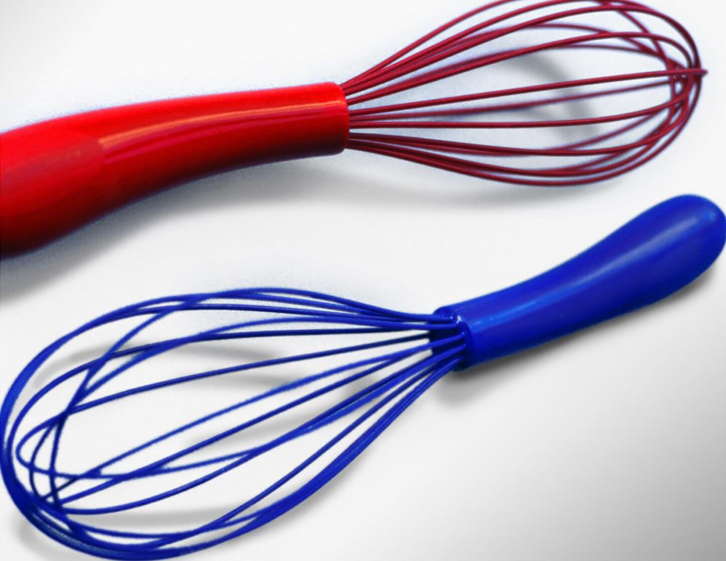 Two silicone whisks on a white background, one red and one blue, with matching handles and wire loops.