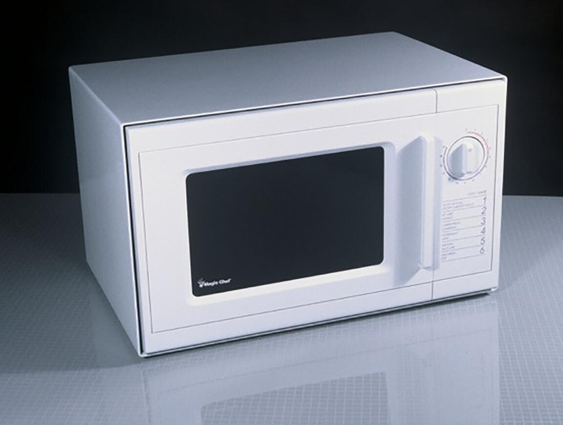 White countertop microwave with a black door window, a control dial on the right, and a side-opening handle, set against a dark background.