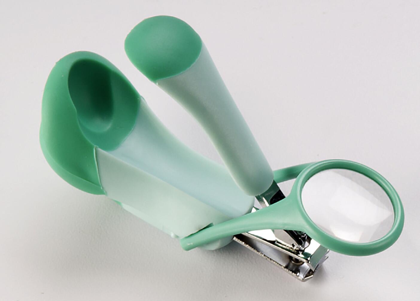 Green and white nail clipper with a magnifying glass attached, set against a plain white background.