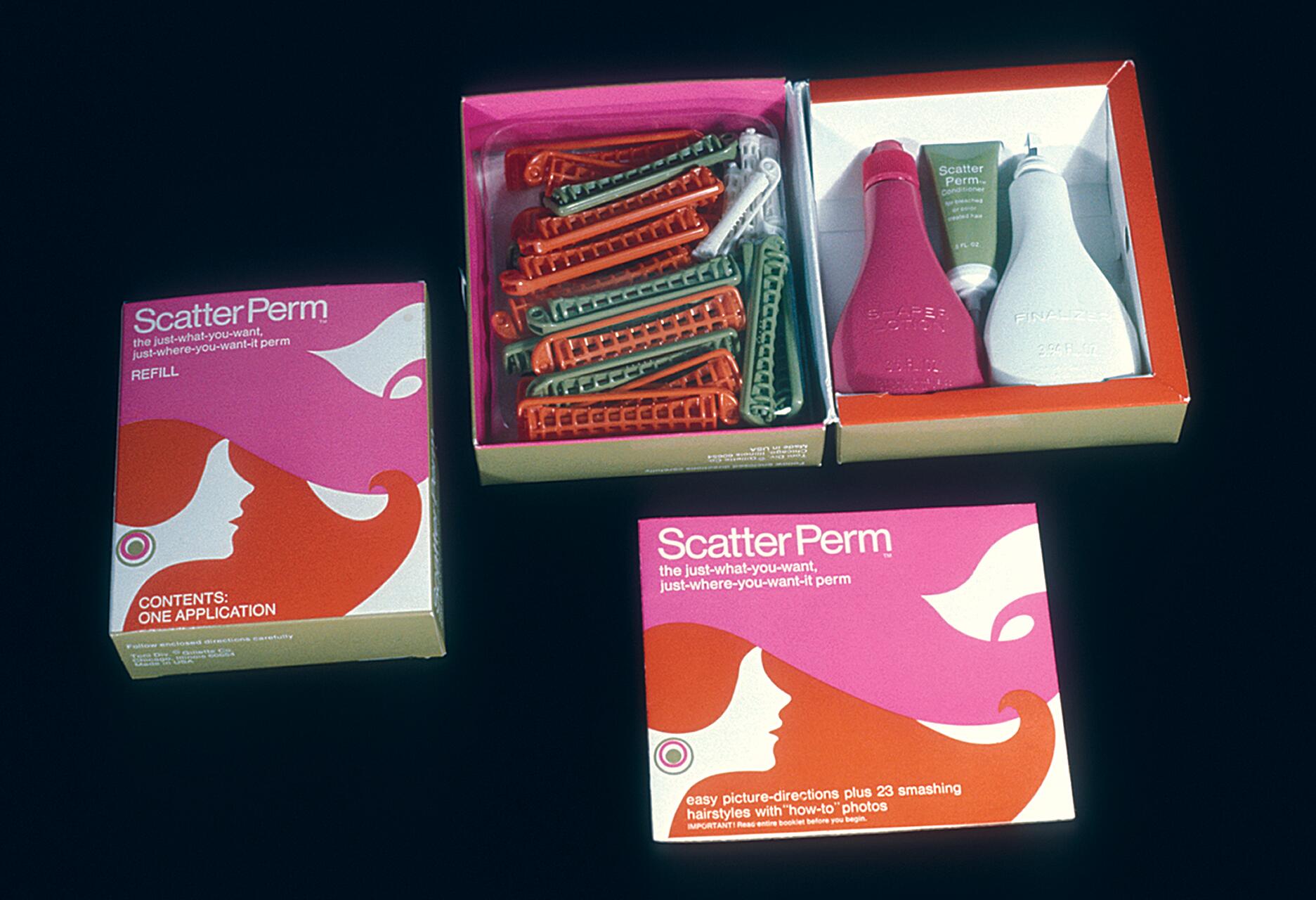 Scatter Perm kit with bottles and curlers in an open box, alongside a smaller closed box, on a black background. The packaging features pink and orange designs.