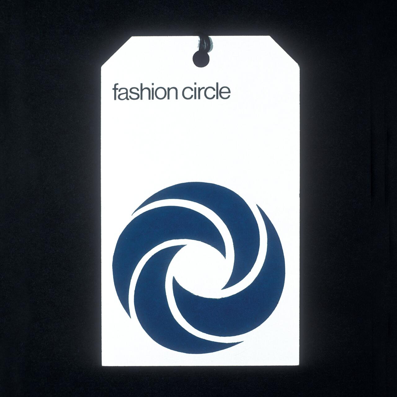 A white tag with the words "fashion circle" at the top and a blue swirling circular logo below, hanging on a black background.
