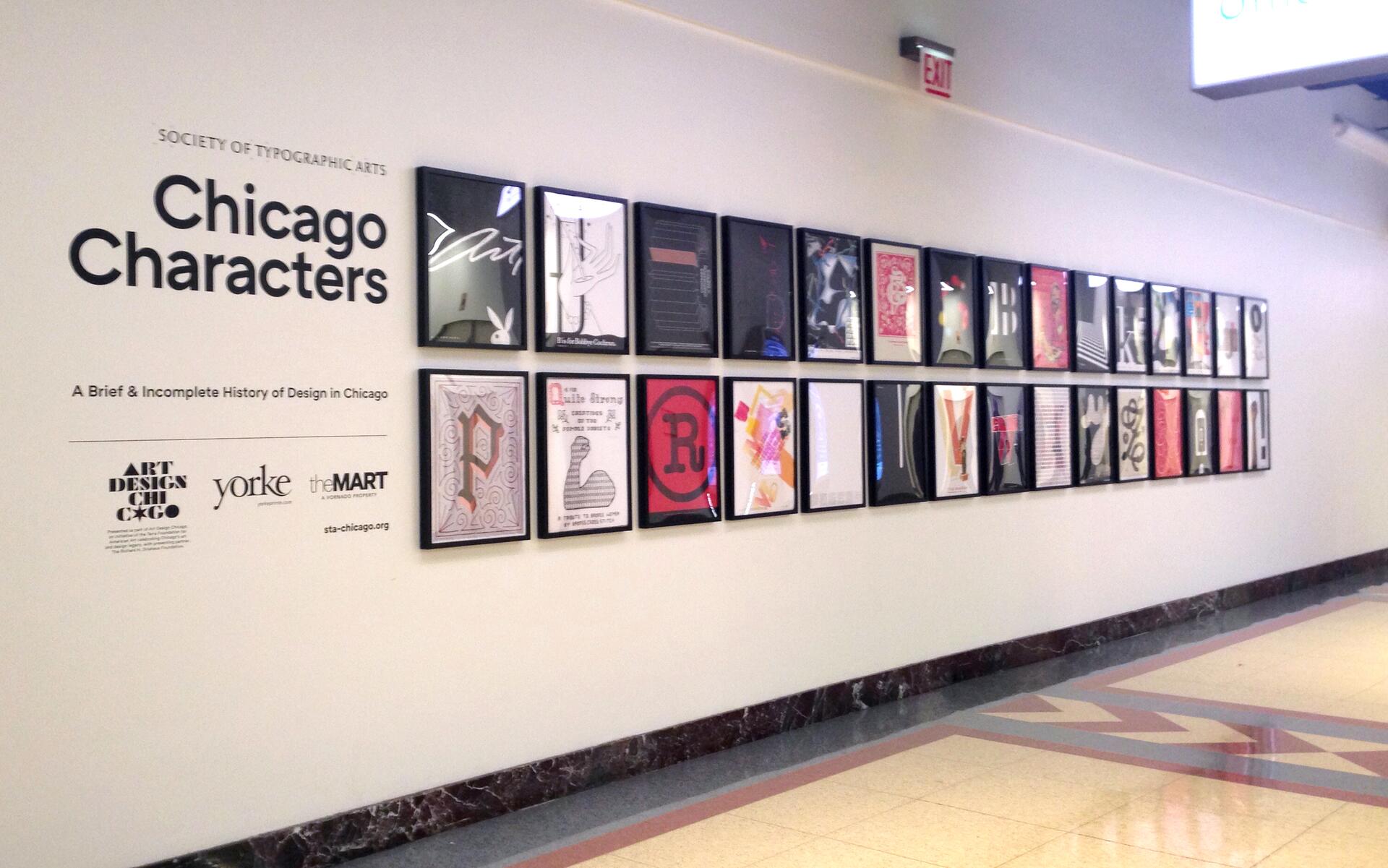 Exhibit wall titled "Chicago Characters" featuring framed typographic posters in a hallway.