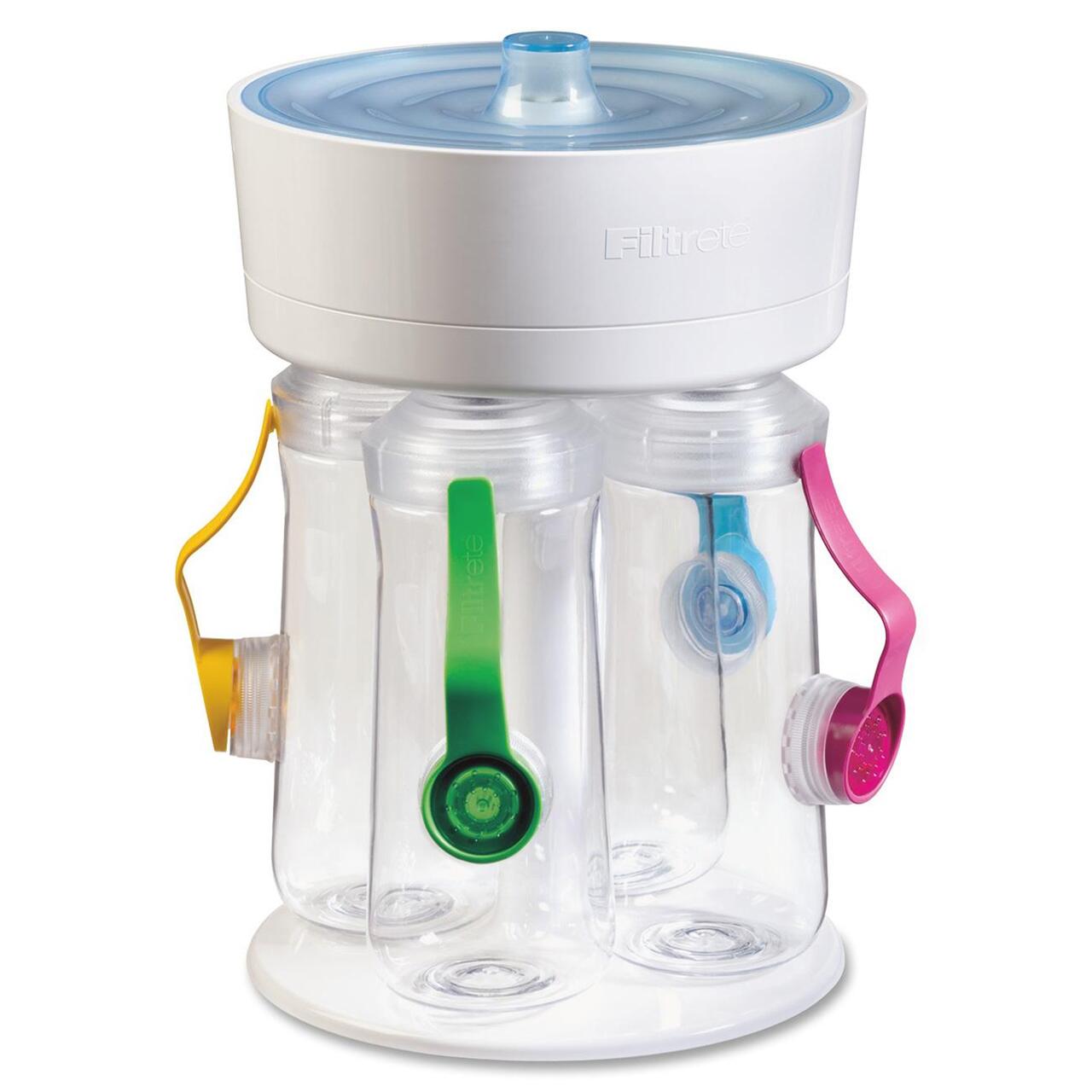 Three clear bottles with colored straps (yellow, green, and pink) are attached to a white filtration system on a round base. The top has a blue circular lid.