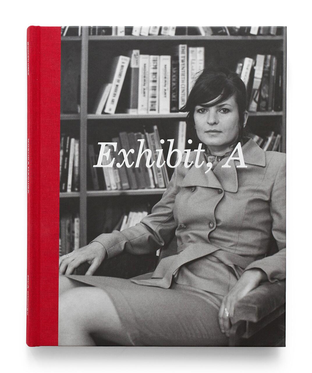 A woman in a tailored suit sits in a library with books on shelves in the background, featured on a book cover titled "Exhibit, A."