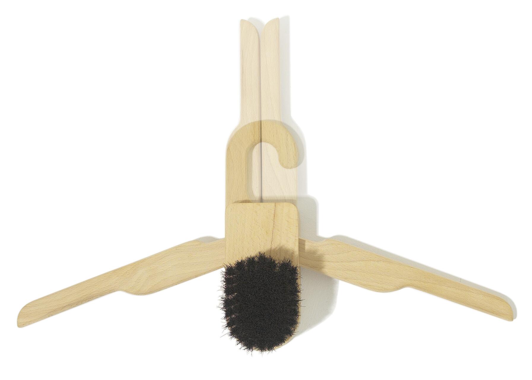 Wooden coat hanger with a black bristle brush attached at the bottom.