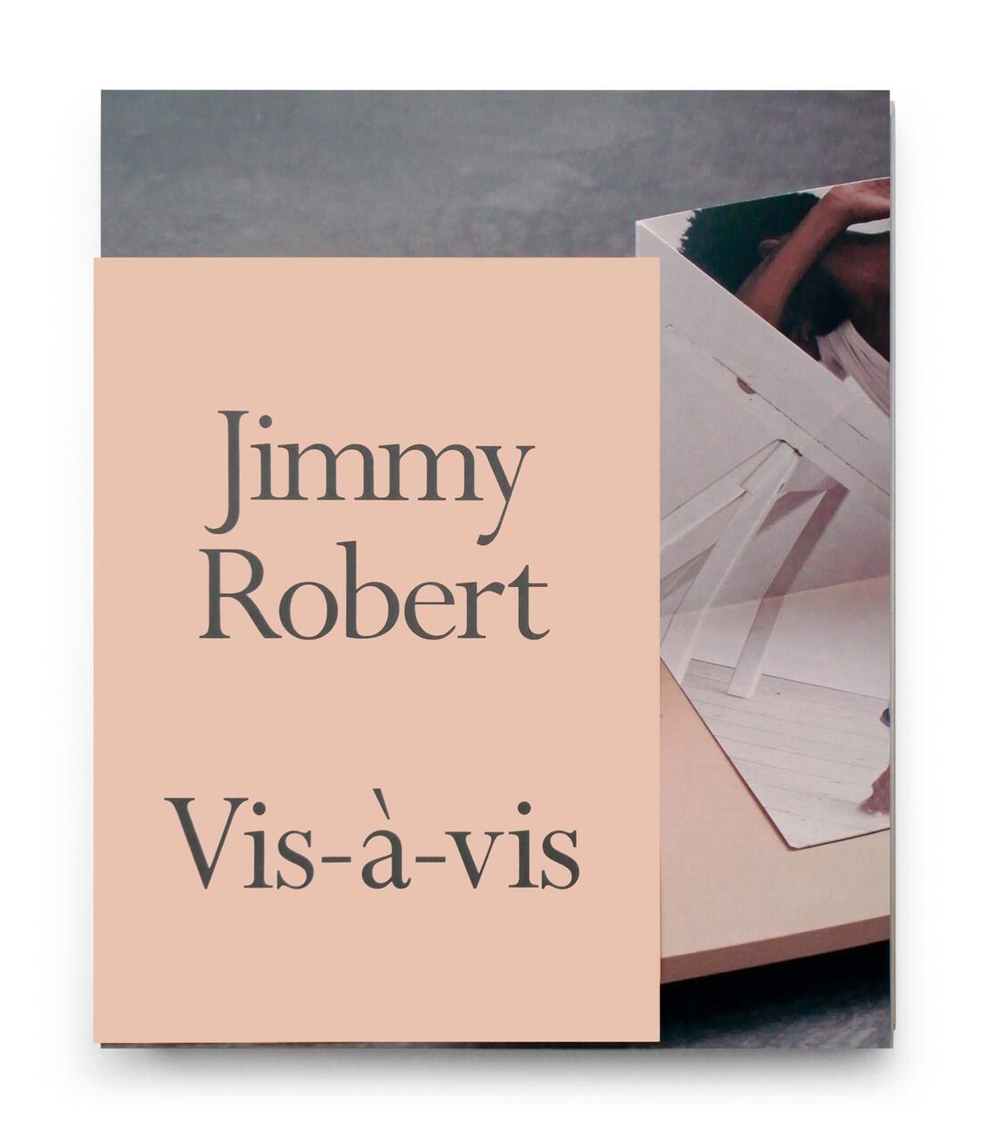 Beige cover with text "Jimmy Robert Vis-à-vis" overlaid on a photo of abstract, geometric papers.