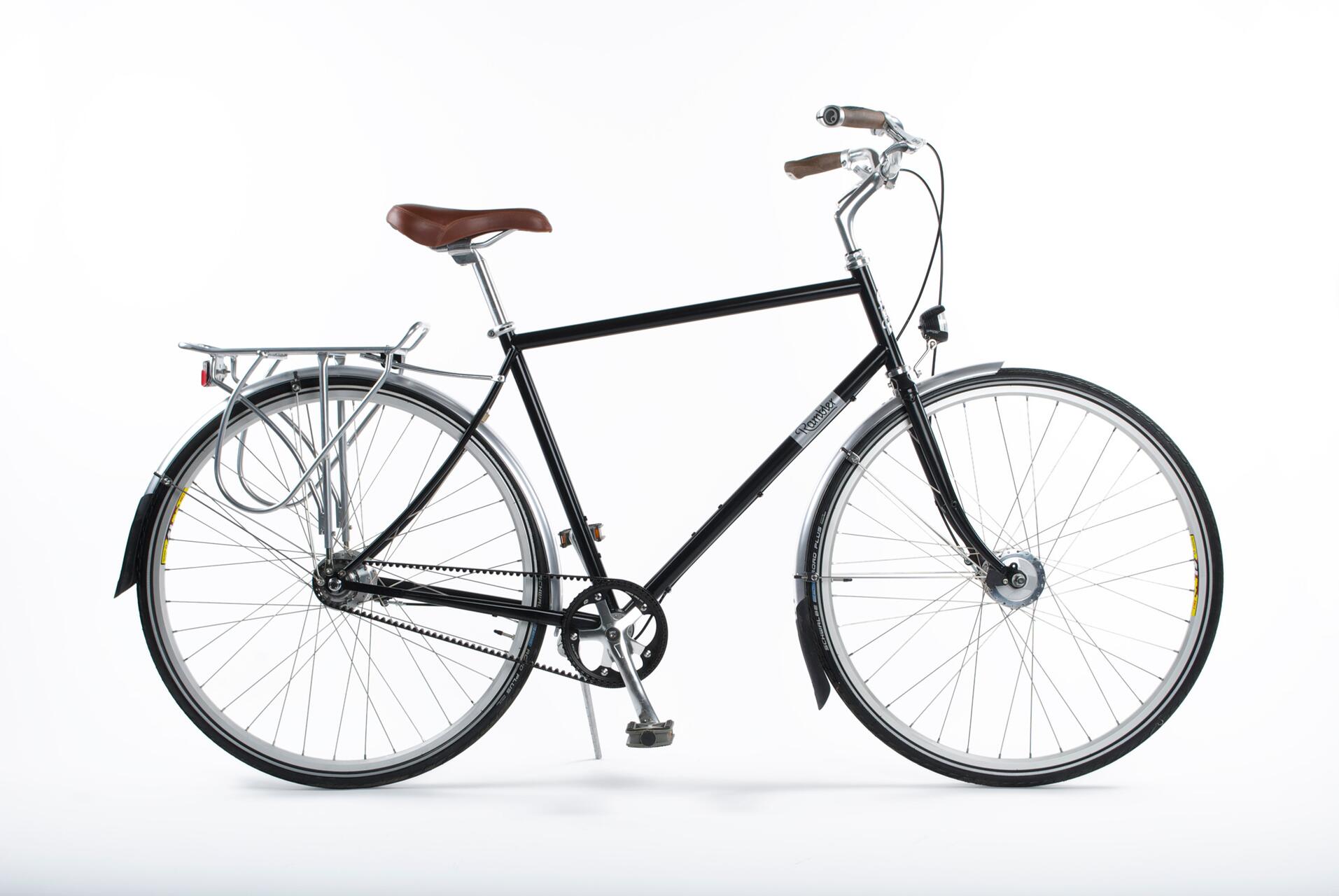Black road bicycle with brown seat and handlebars, featuring a minimalistic design and a rear cargo rack, set against a plain white background.