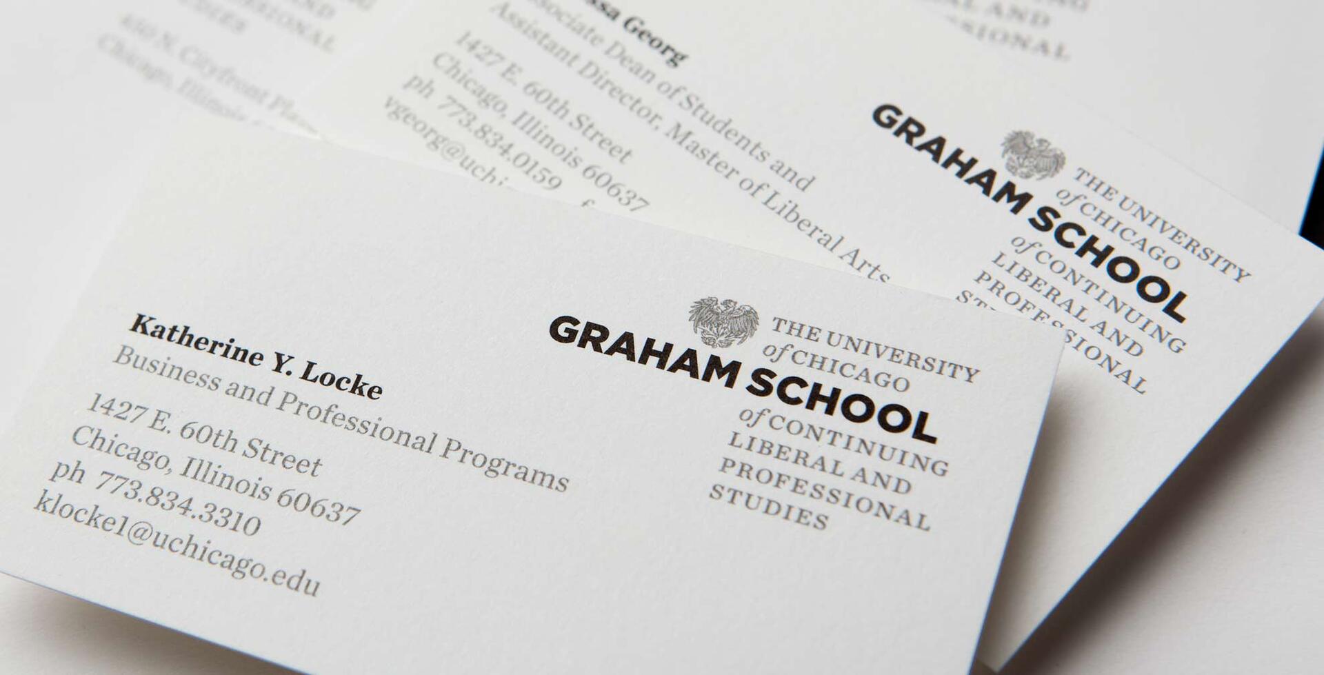 Business cards for the University of Chicago Graham School of Continuing Liberal and Professional Studies, featuring contact information for individuals associated with the school.