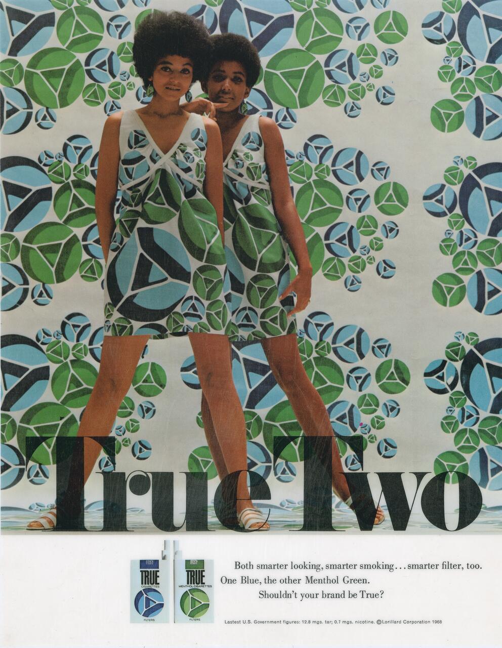 Two people wearing dresses with a geometric green and blue pattern, standing against a matching patterned background. The word "True" is printed across the bottom, partially covering their legs.