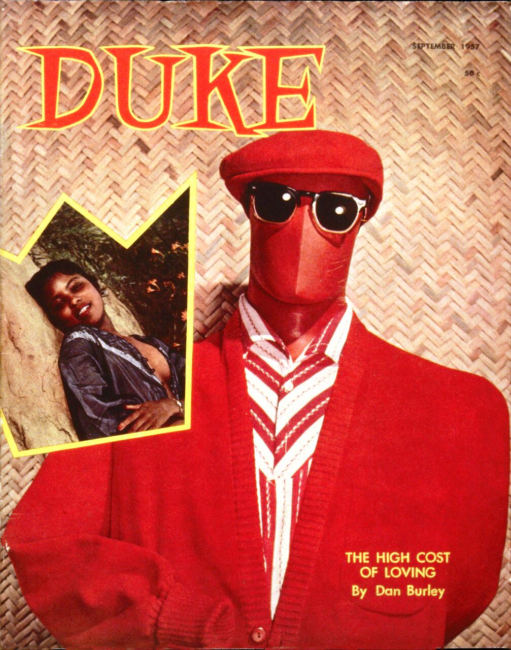 Magazine cover with a red-clad figure wearing sunglasses and a matching cap, face masked. Background features a woven pattern. Inset photo of a smiling woman leaning against a tree. Text reads "DUKE" and "THE HIGH COST OF LOVING."