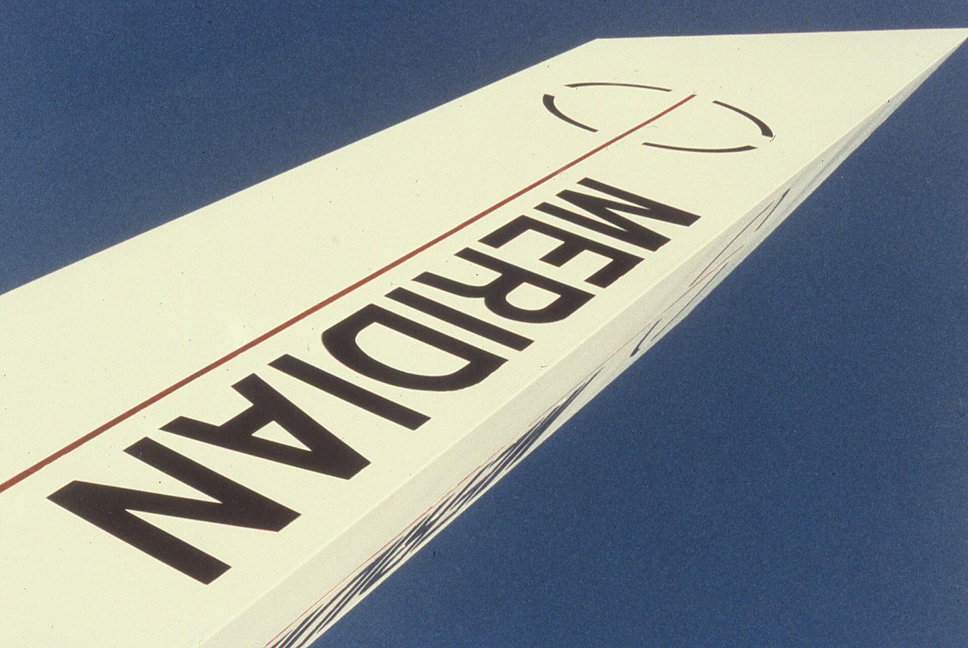 Airplane tail with "MERIDIAN" printed in large black letters against a clear blue sky.