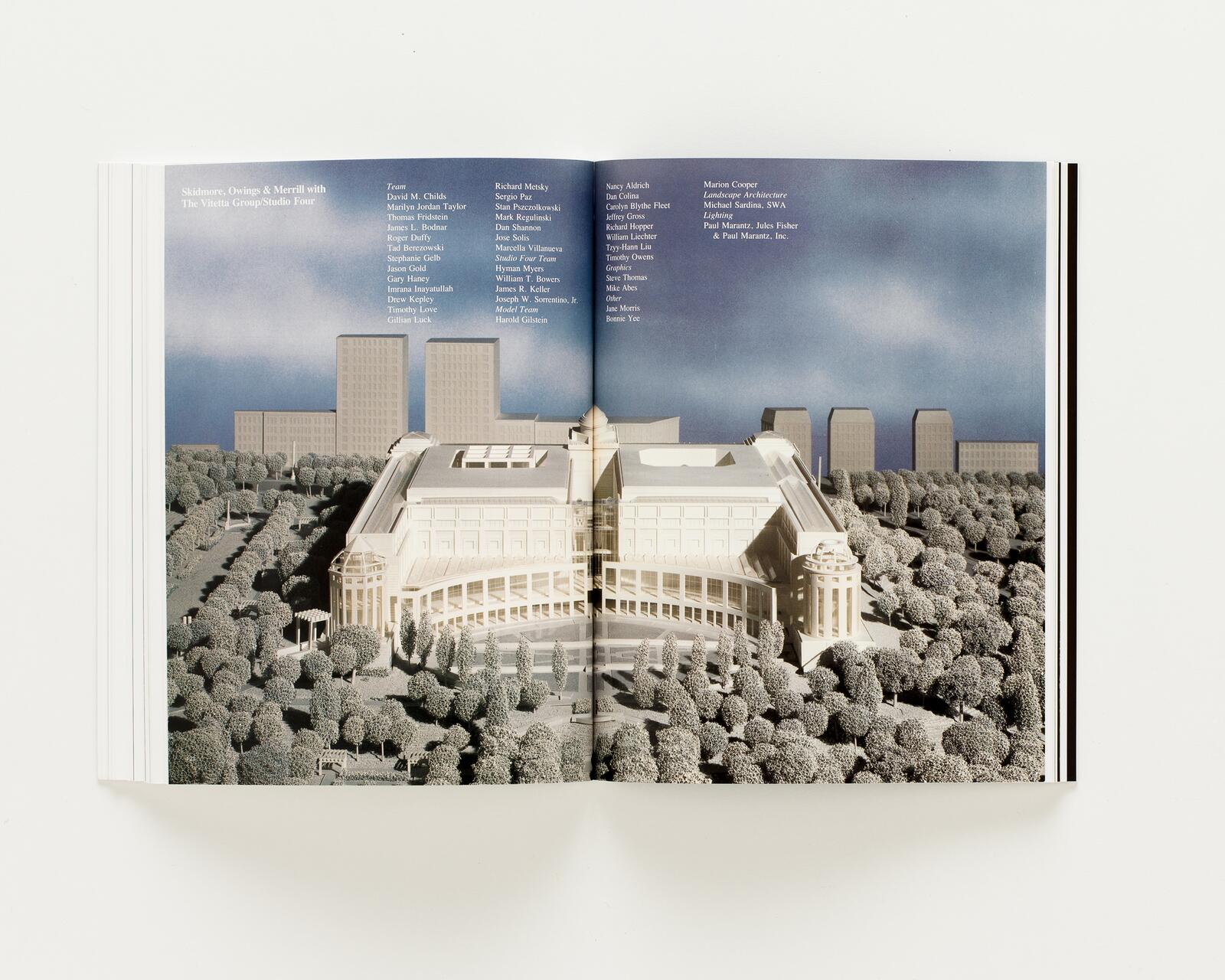 Open book displaying an architectural model with a large, neoclassical building surrounded by trees, set against a backdrop of blue sky and modern high-rise buildings.