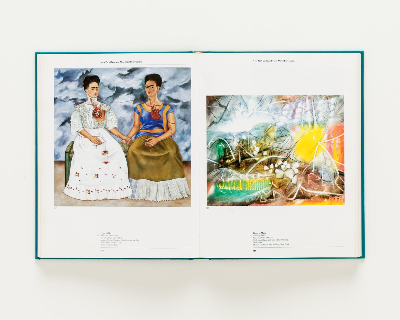 An open book showing a colorful portrait of two women holding hands on the left and an abstract artwork with bright yellow and orange hues on the right.