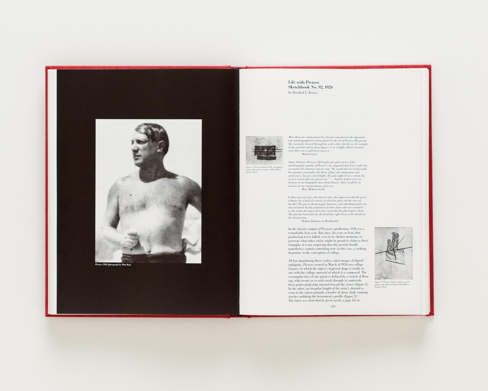 Open book spread featuring a black-and-white photograph of a shirtless man on the left page. The right page contains text and two small illustrations. The book has a red cover.