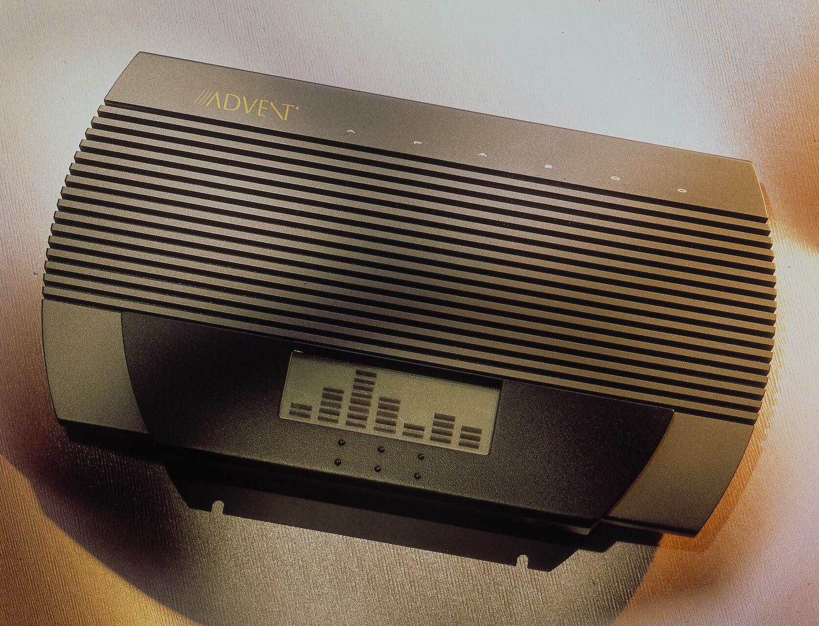 Retro electronic device with horizontal ridges, a small display showing a bar graph, and "Advent" branding on a metallic surface.