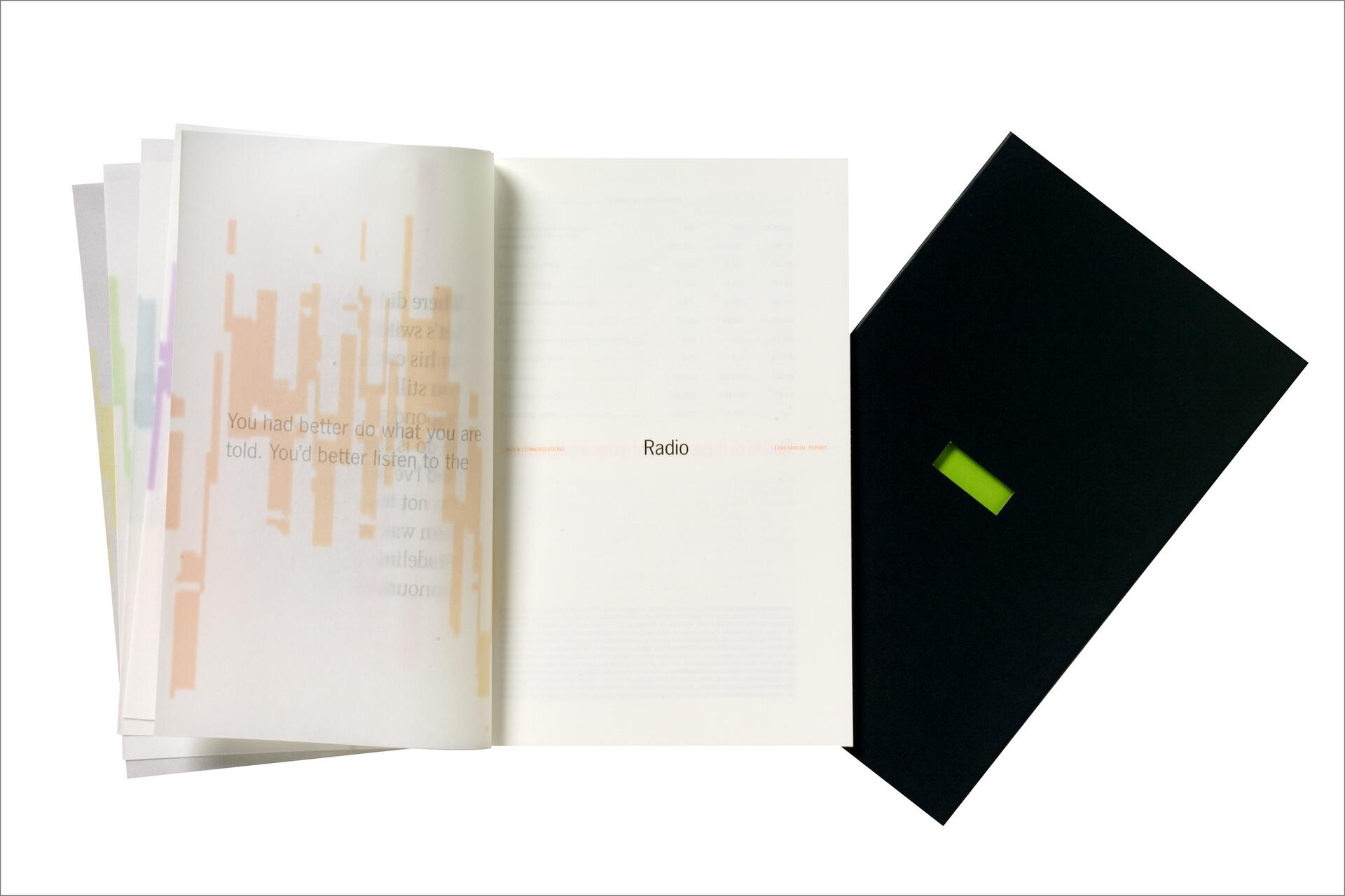 Open book next to a black cover with a small green rectangle, showing text on partially transparent pages.