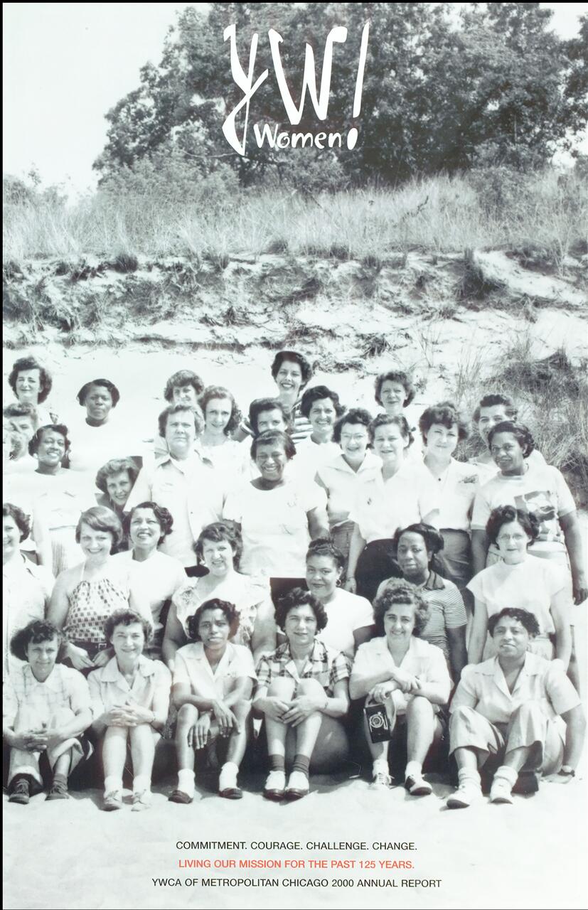 A vintage black and white photograph of a diverse group of women sitting and standing on a sandy dune, with trees in the background. The image includes the text "YW Women!" at the top.