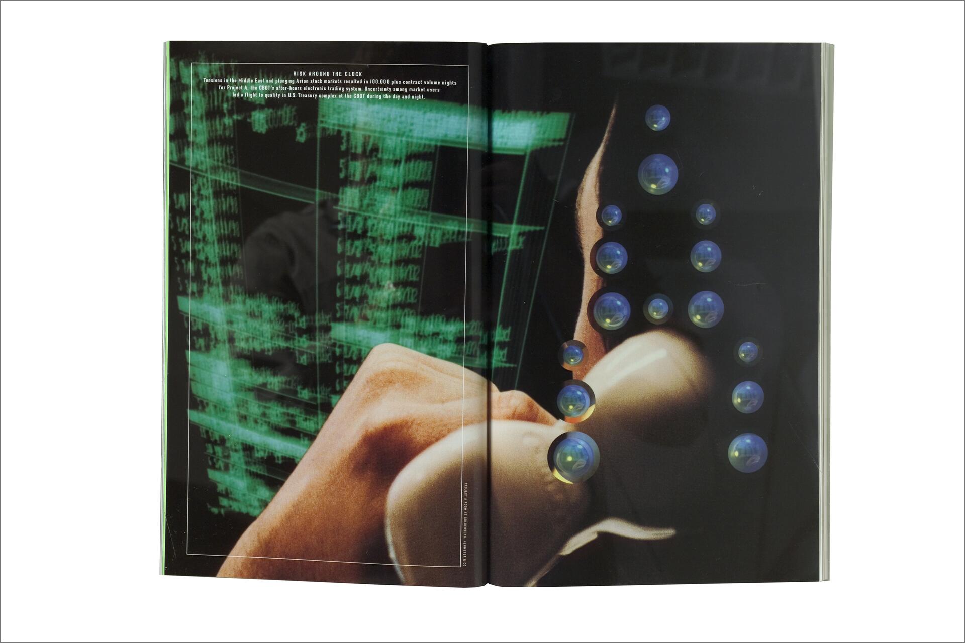 Open magazine with green digital graphics on the left page and a hand holding an object on the right page, overlaid with blue bubbles.