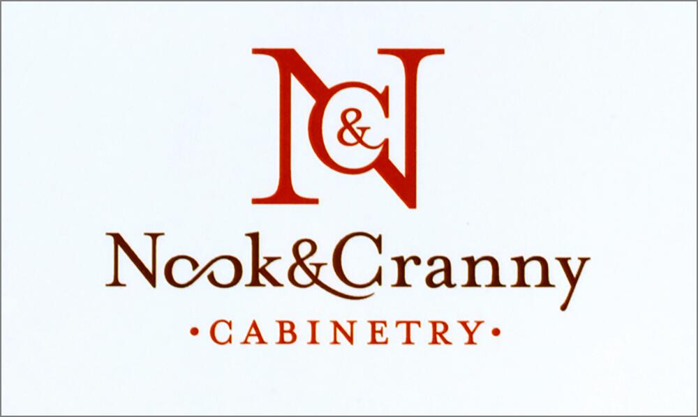 N&N logo for Nook & Cranny Cabinetry in brown and red with ornate fonts on a white background.