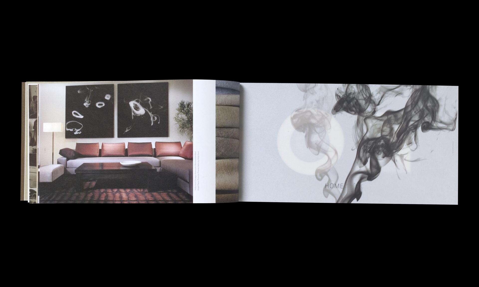 Open book featuring a modern living room with a sectional sofa and abstract wall art on the left page, and swirling grey smoke on a light background on the right page.