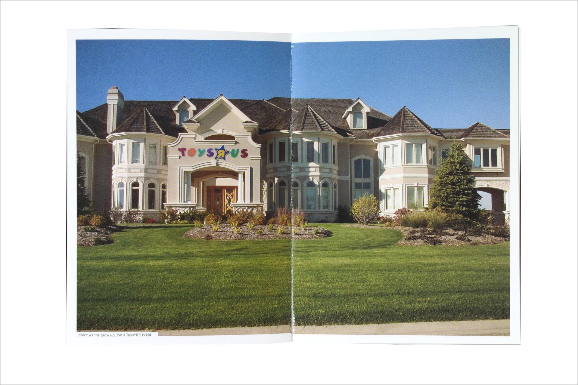 Large mansion with a "Toys R Us" sign above the entrance, surrounded by manicured lawns and gardens under a clear blue sky.