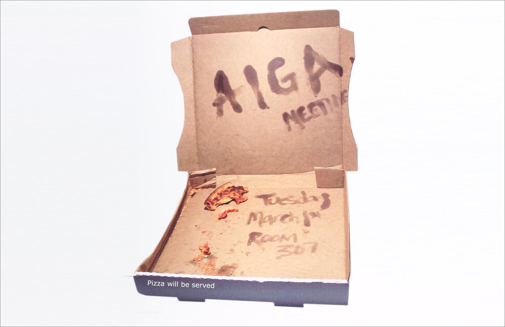 Empty pizza box with remnants of crust. Words written outside and inside the lid indicate a meeting and a date.