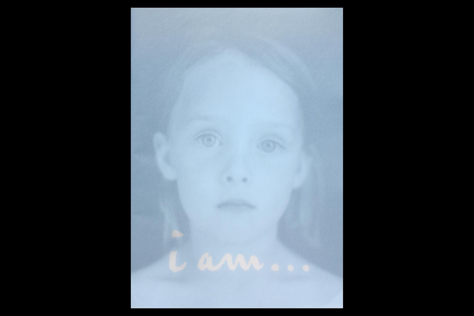 A faded, monochromatic photograph of a young child with a neutral expression, looking directly at the viewer.