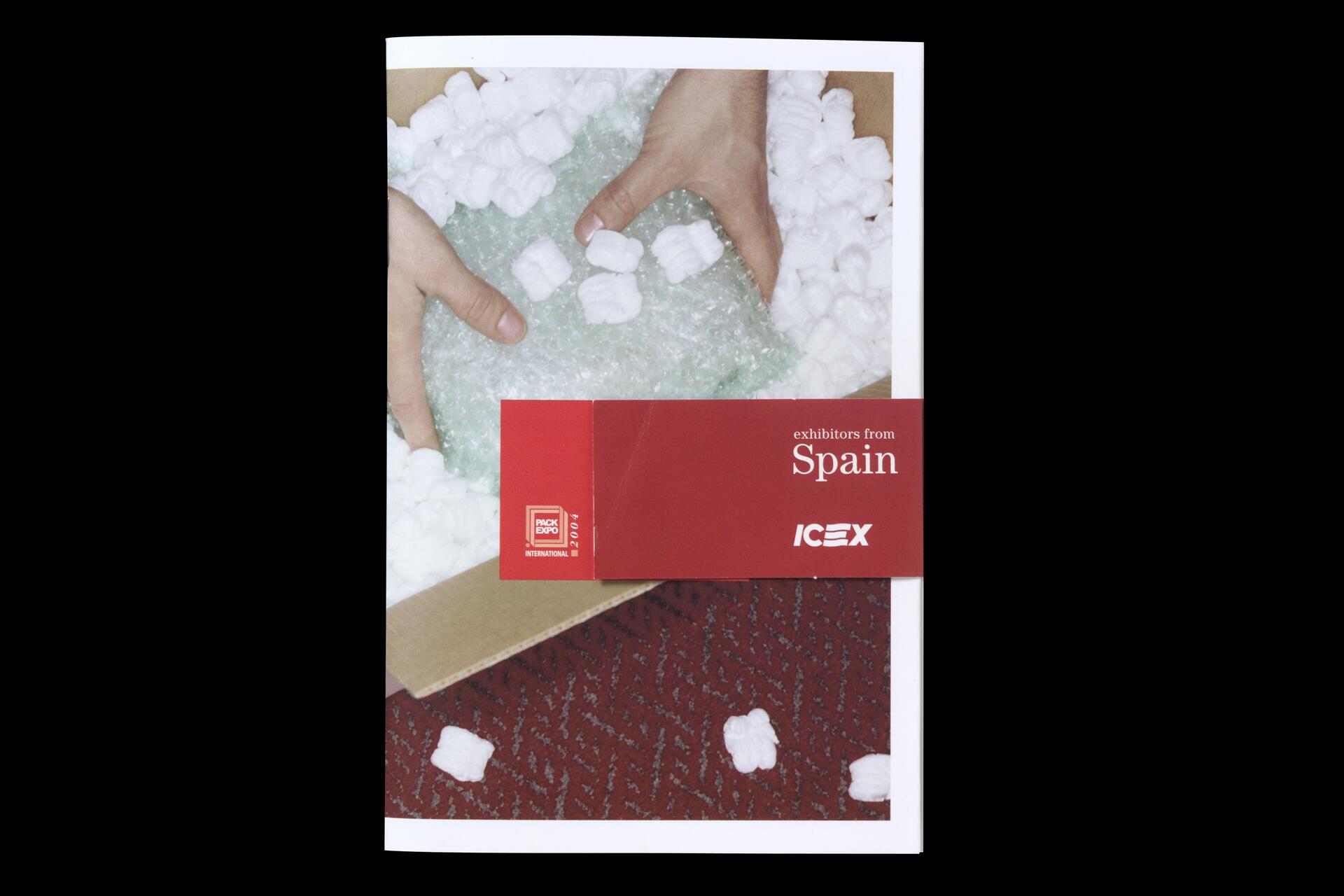 Hands handling bubble wrap and packing peanuts in a cardboard box, with a red booklet overlay titled "exhibitors from Spain" and a logo.