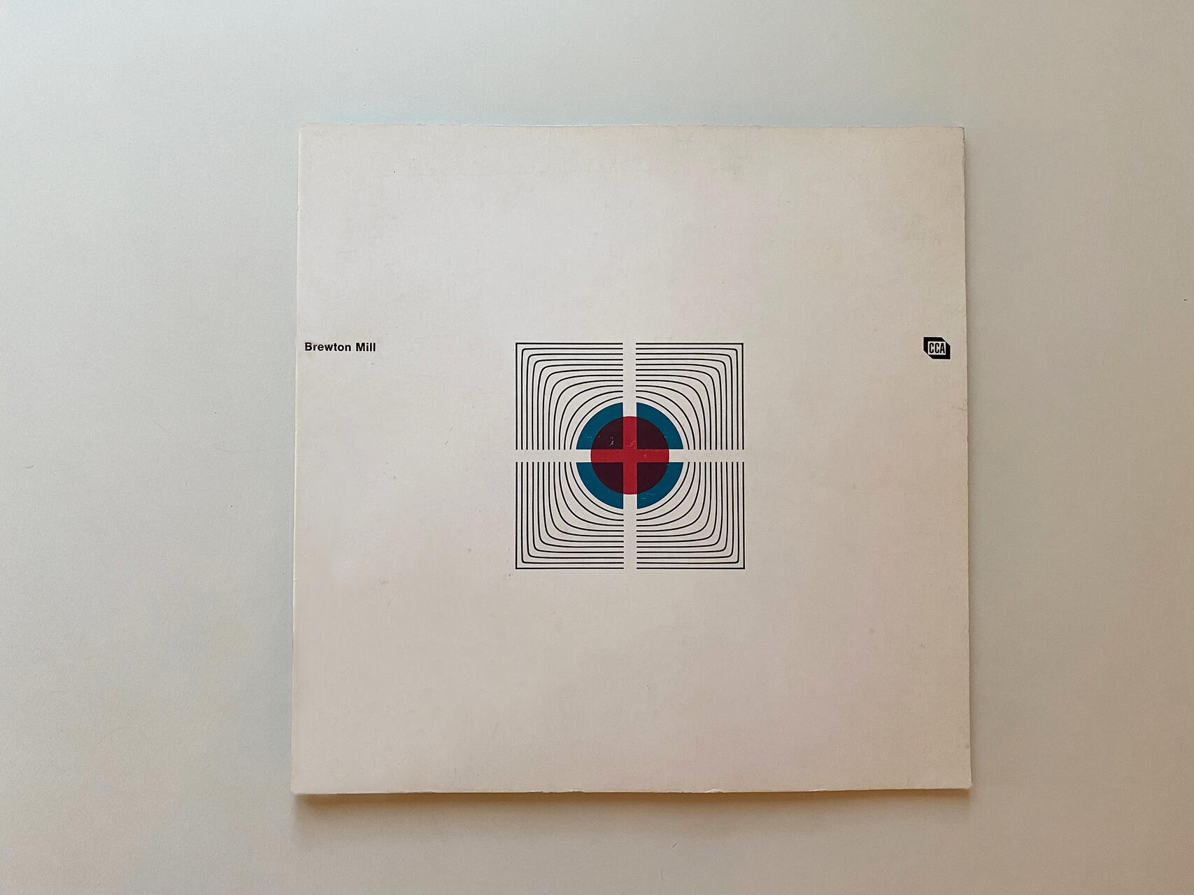 White album cover with a geometric design: concentric black lines forming a square around a red and blue cross in the center, and small text on the side.