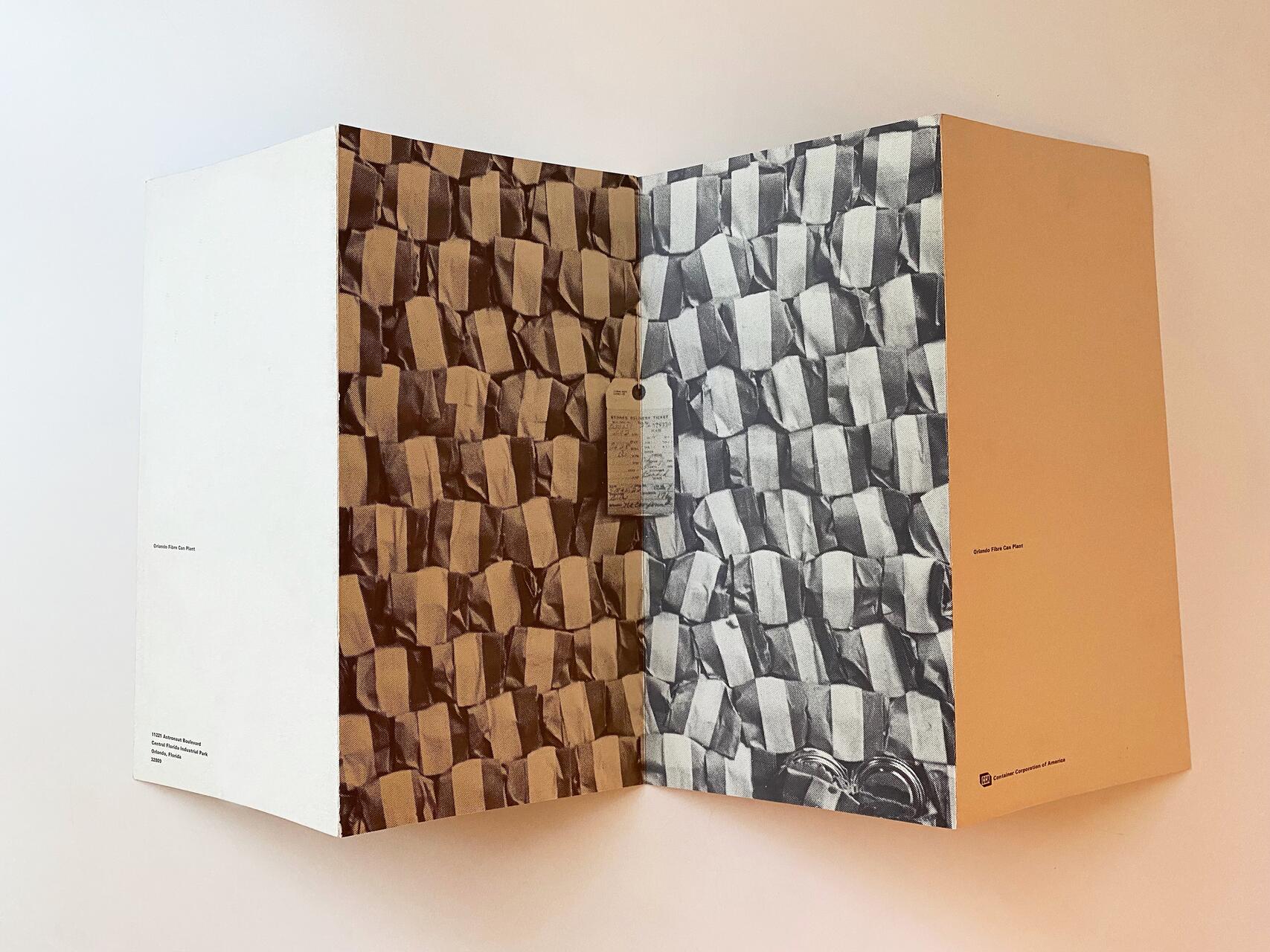 Open magazine showing a brown-toned page on the left with a pattern of stacked, folded squares, and a black-and-white page on the right with a similar pattern. A small piece of paper is pinned to the center fold. Pages have minimal text.