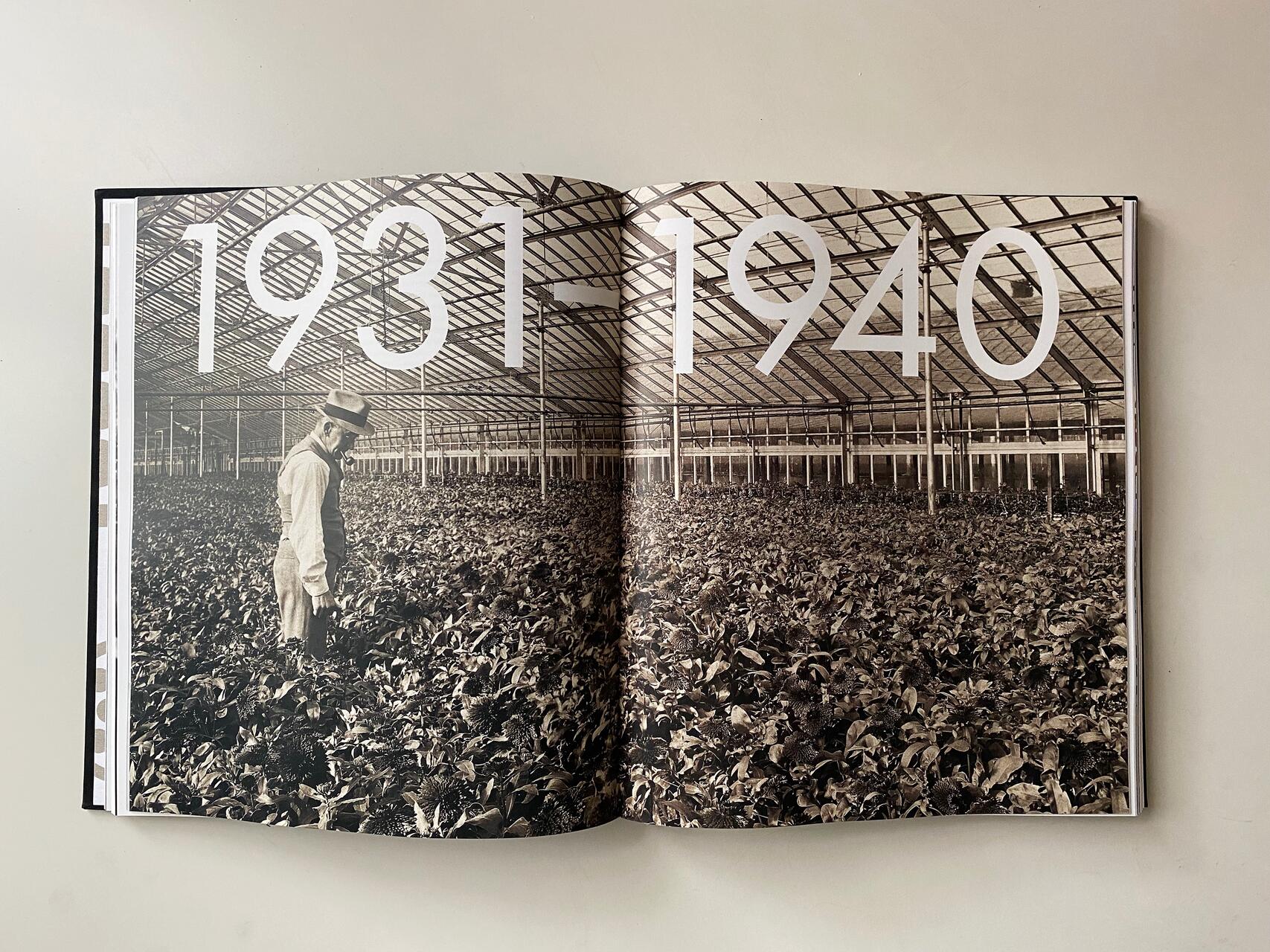 Black and white photo of a man in a suit and hat standing in a large greenhouse filled with plants. Large text on the image reads "1931-1940."