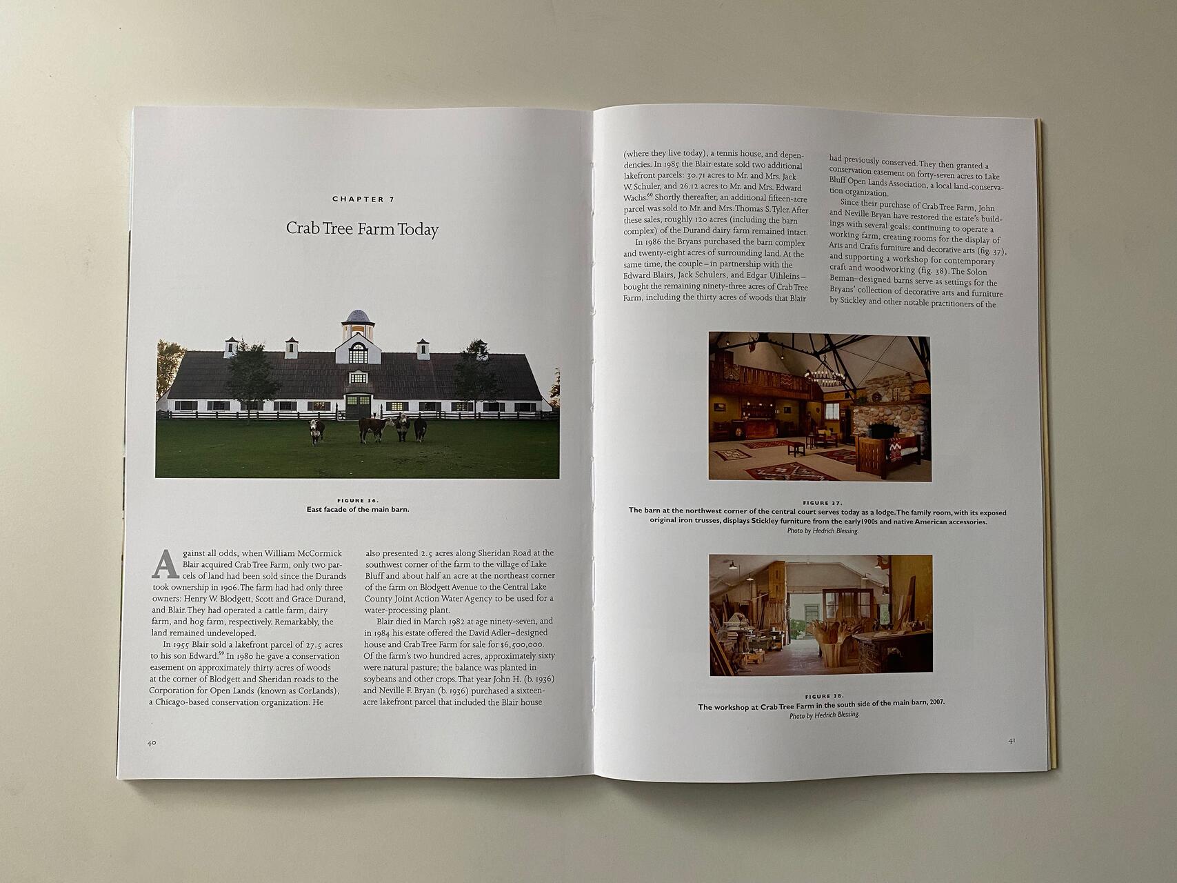 Two-page spread from a book about Crab Tree Farm. Left page: Image of the main barn's east facade. Right page: Photos show a lodge with Stickley furniture and a workshop with carpentry tools from 2007. Text describes the farm's history and current use.