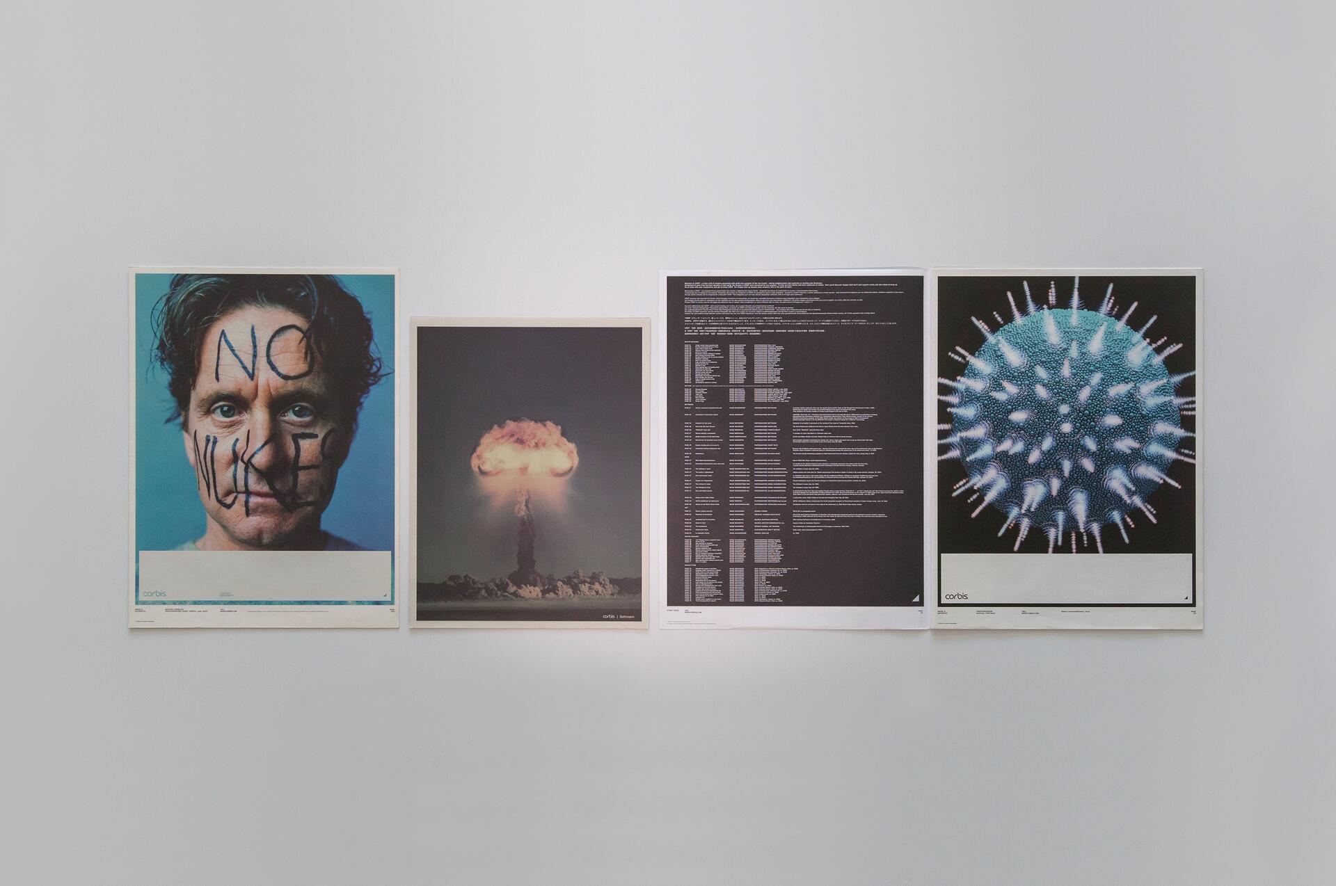 Four posters on a wall: a face with "No Nukes" written on it, a nuclear explosion, text-heavy information, and a close-up of a blue virus-like structure.