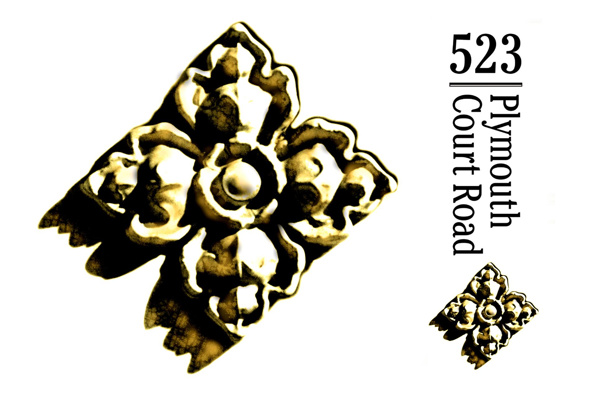 Yellow flower-shaped metal ornament with floral patterns, placed on a white background next to vertical text reading "523 Plymouth Court Road."
