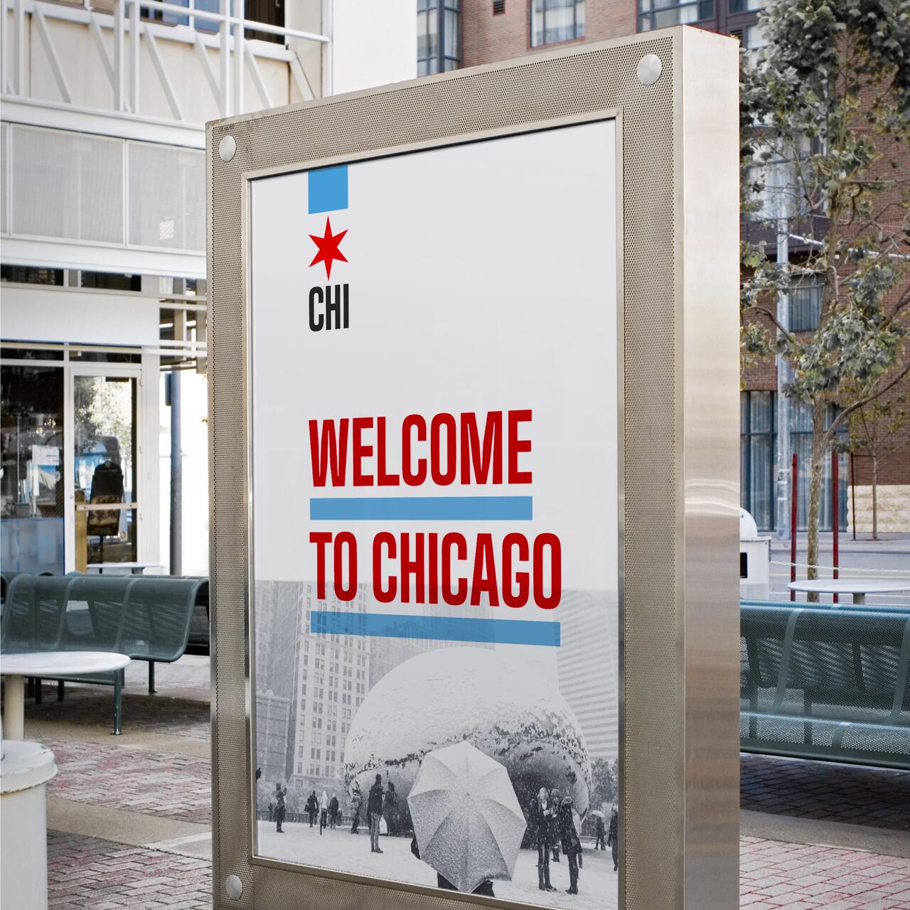 Welcome to Chicago poster with the city's star symbol, featuring a snowy scene of people by the Cloud Gate sculpture, also known as "The Bean." The poster is displayed outdoors in an urban setting.