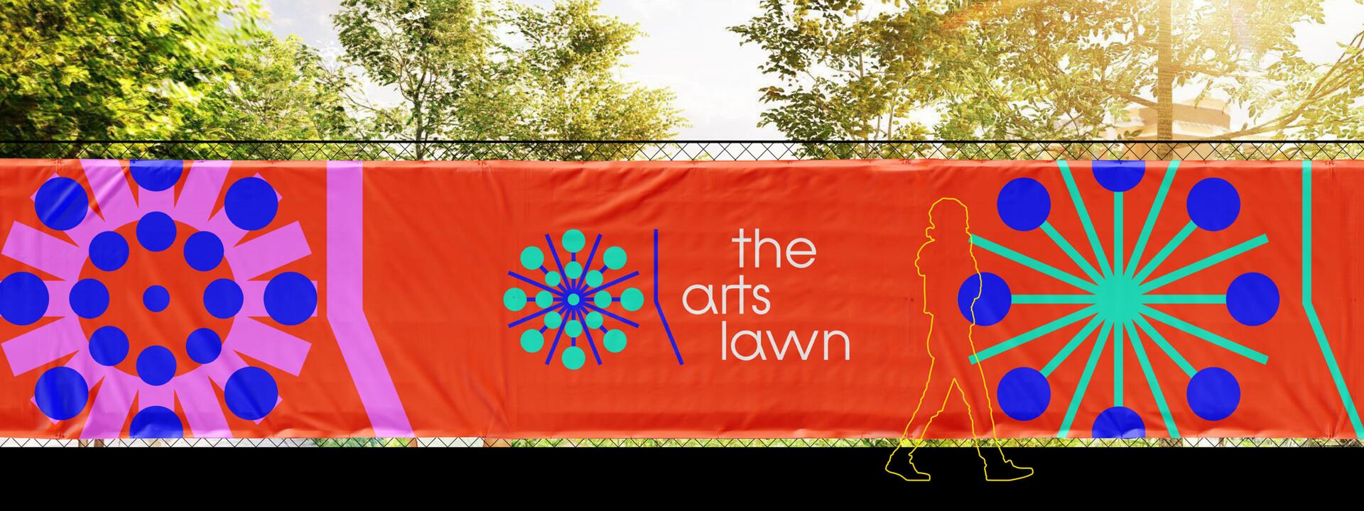 A vibrant orange banner with abstract blue and green circular designs and the text "the arts lawn" in white. A silhouette of a person walks in front of it, with trees and sunlight in the background.