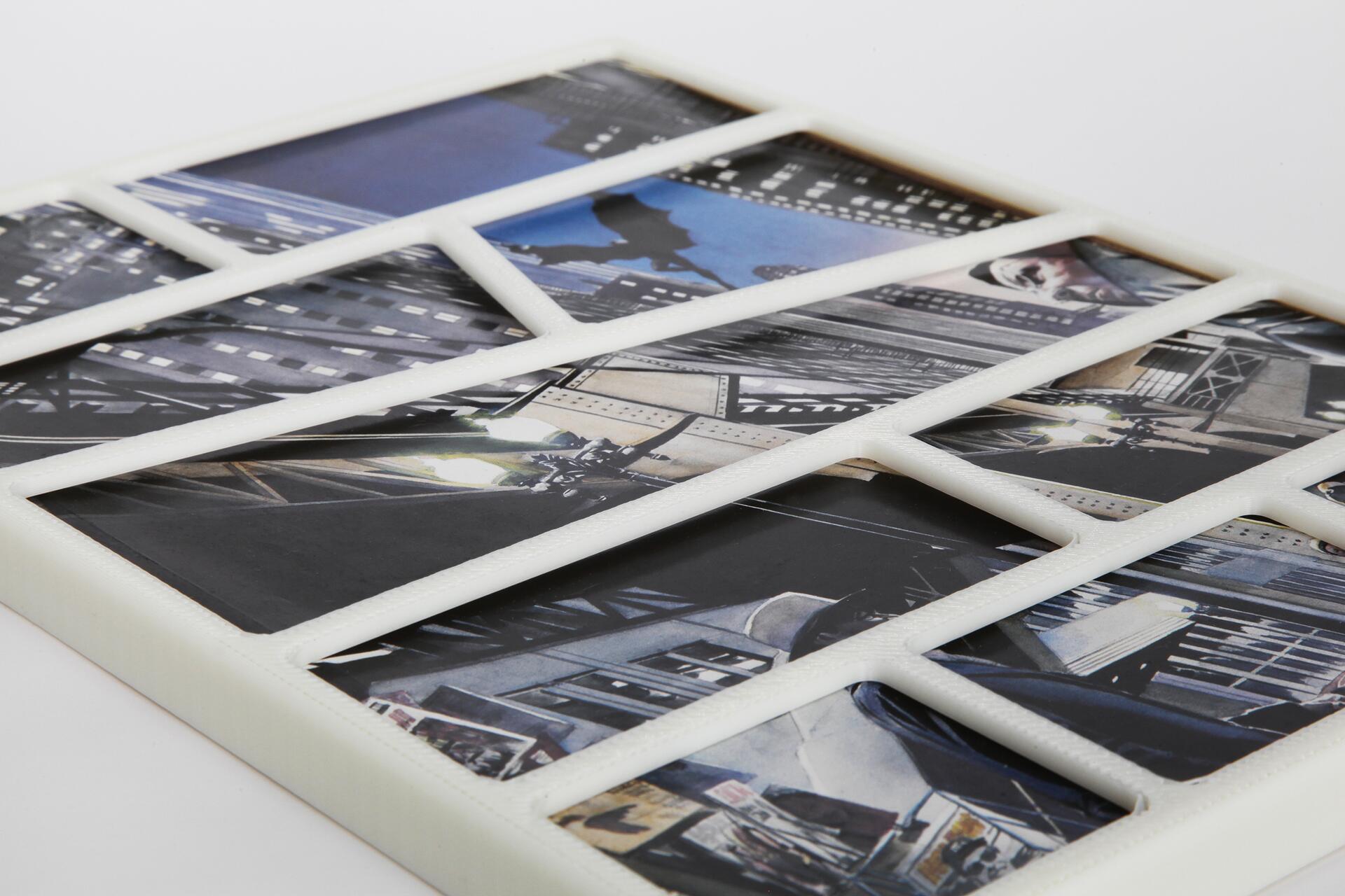 Collage of urban scenes with skyscrapers and streets, viewed through a white grid-like frame.