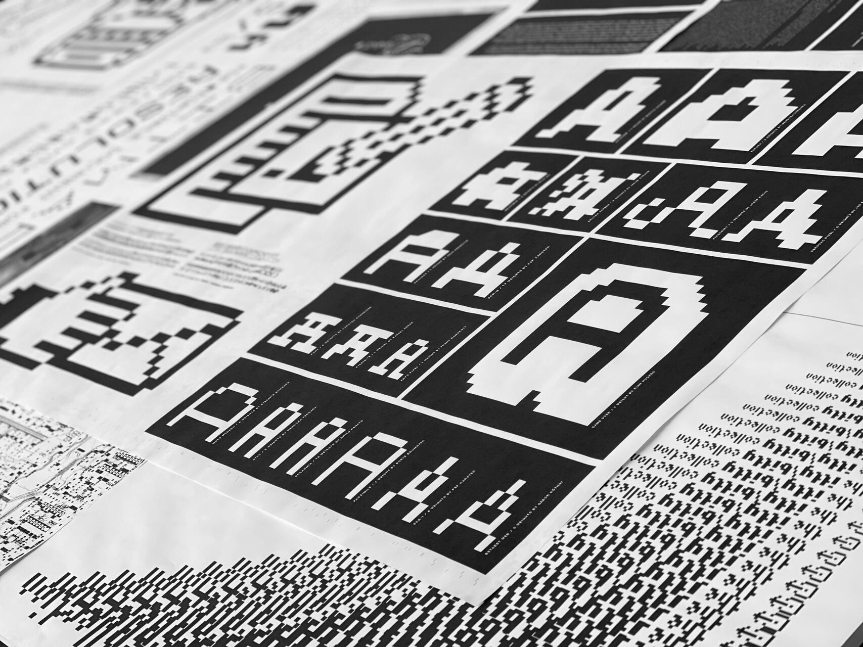 Black and white poster featuring pixelated designs and letters, arranged in a grid pattern.