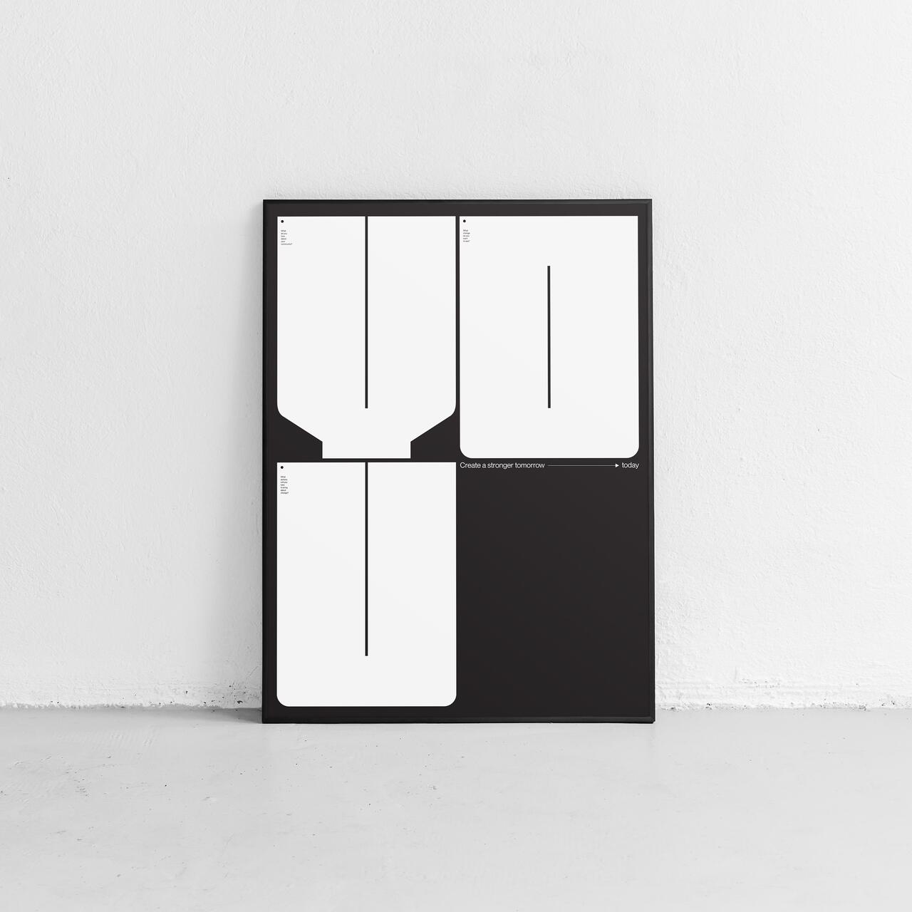 Minimalist poster leaning against a white wall, featuring bold black and white geometric shapes arranged in a grid on a black background.
