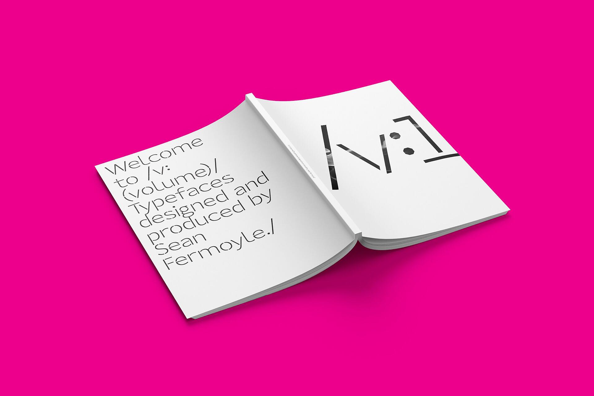25B-11a_/v: Magazine — Issue 1 - Open book on a bright pink background with modern typography designs and text on the left page_Sean Fermoyle