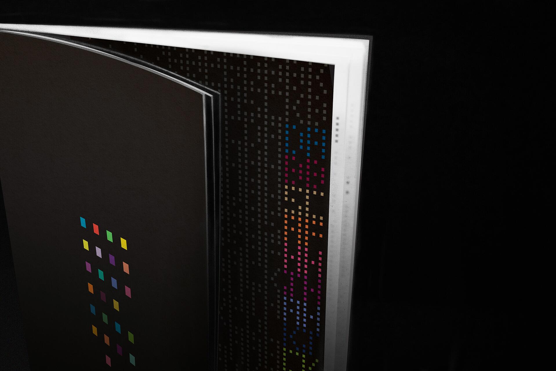 16A-35_Open book black book with colorful square patterns on black pages_Dani Reis