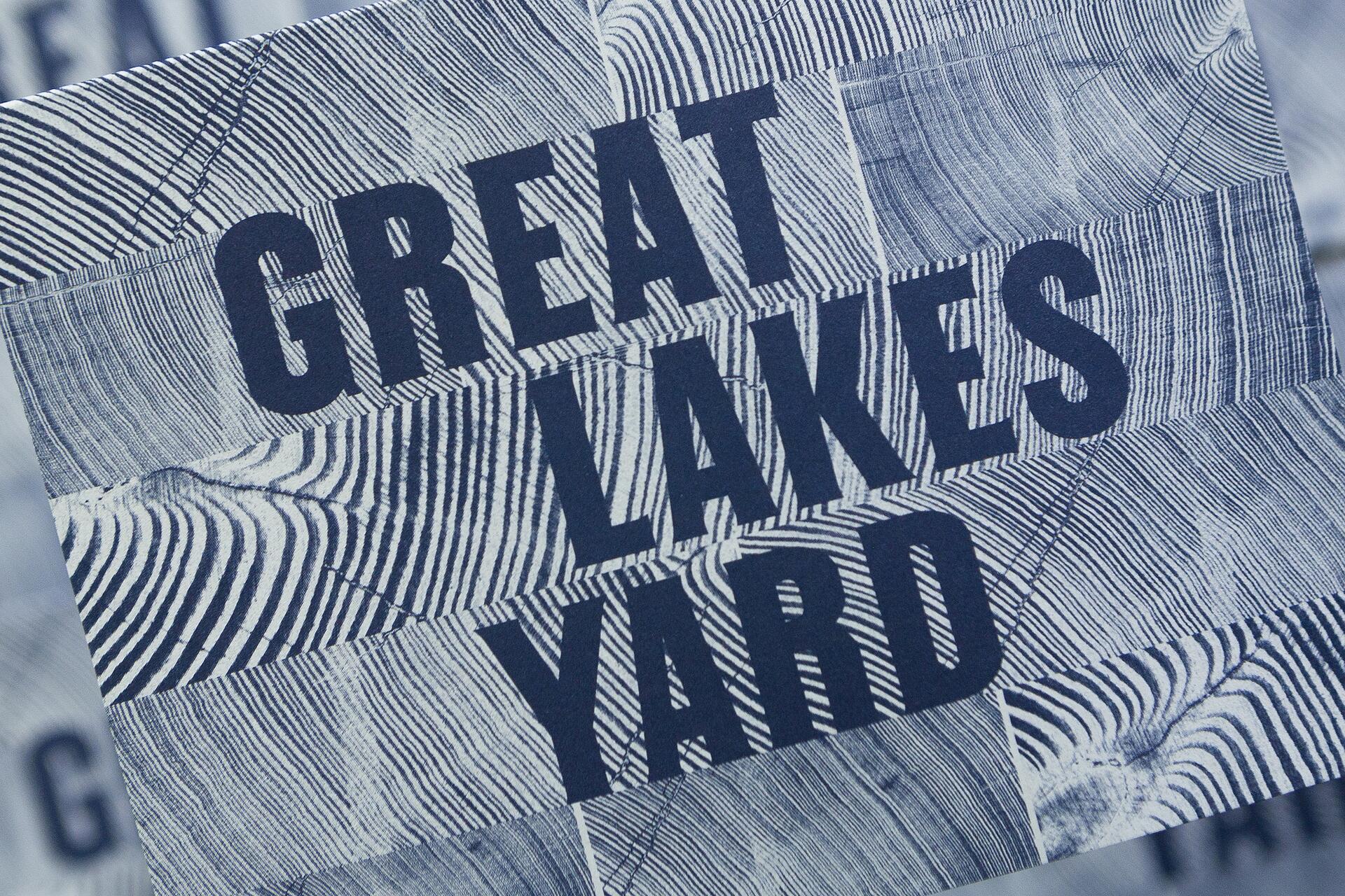16A-36_"Great Lakes Yard" text on a wood grain patterned background in blue tones_Nick Adam