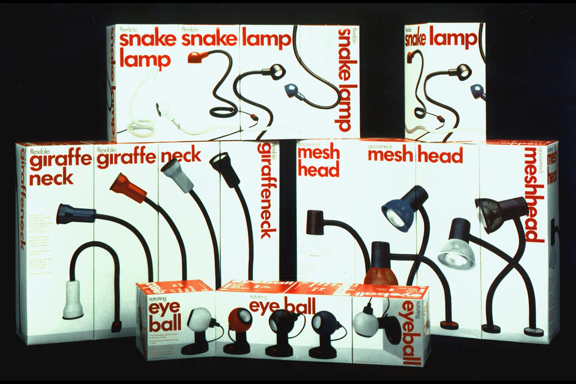 Stacked boxes of flexible lamps, including snake, giraffe, and mesh head designs, with bold red and black text. Each box features an image of the lamp it contains, in various colors, against a white background.