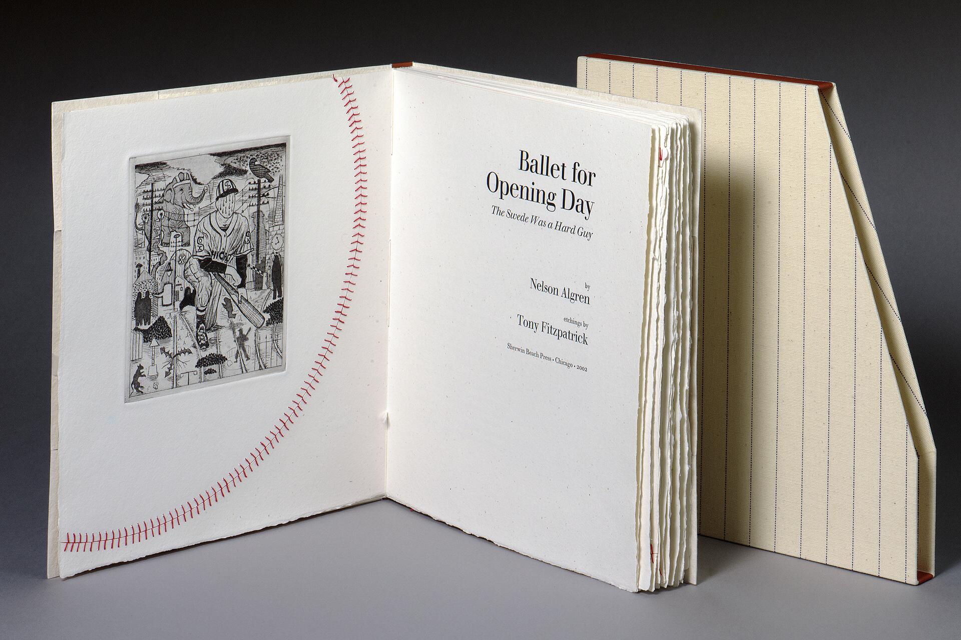 Open book with a baseball-themed illustration on the left page and text titled "Ballet for Opening Day" on the right. The book cover resembles a baseball with red stitching. Beige and pinstriped slipcase is partially visible.
