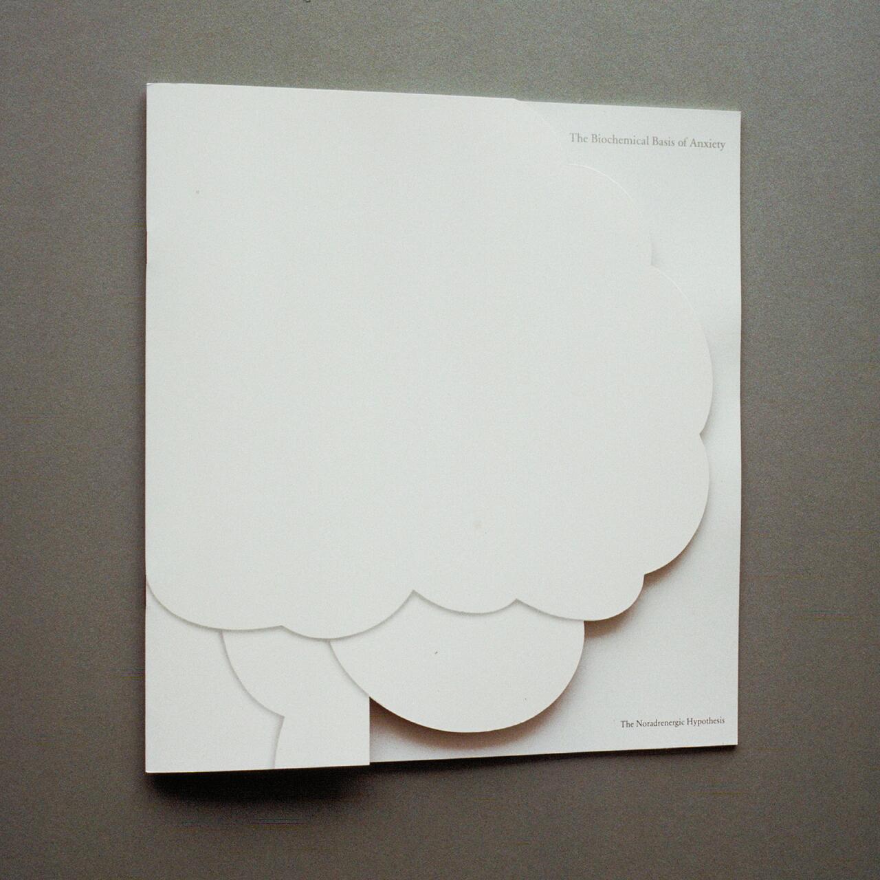 White paper with scalloped edges resembling a thought bubble against a gray background. Small printed text reads "The Biochemical Basis of Anxiety" and "The Noradrenergic Hypothesis" in the top right corner.