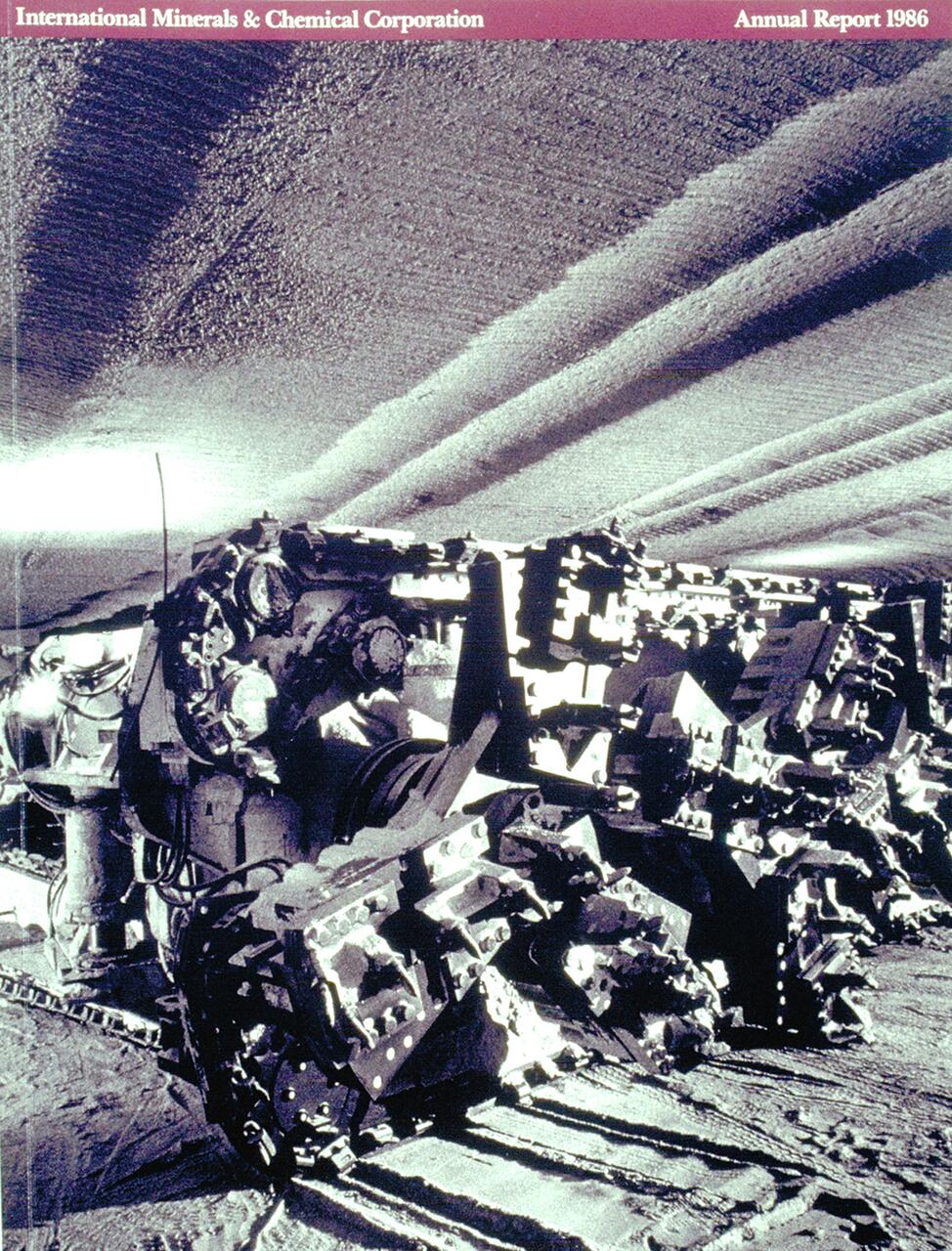 A large industrial machine with gears and blades operates in an underground mine, casting dramatic shadows on the textured ground and walls. The setting is metallic and monochromatic, conveying a sense of industry and scale.